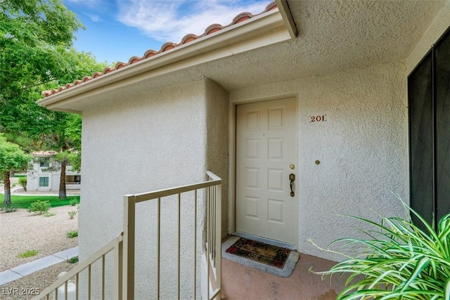 2627 S Durango Dr Unit 201, Las Vegas, NV 89117 - doorway to property with stucco siding and a tile roof