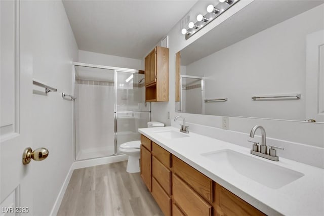 2627 S Durango Dr Unit 201, Las Vegas, NV 89117 - bathroom with a shower stall, wood finished floors, and double vanity