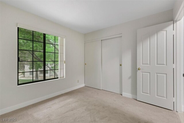 2627 S Durango Dr Unit 201, Las Vegas, NV 89117 - unfurnished bedroom with light carpet and a closet
