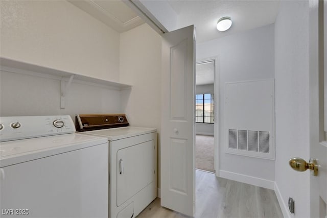 2627 S Durango Dr Unit 201, Las Vegas, NV 89117 - laundry area featuring washing machine and clothes dryer and light wood-type flooring