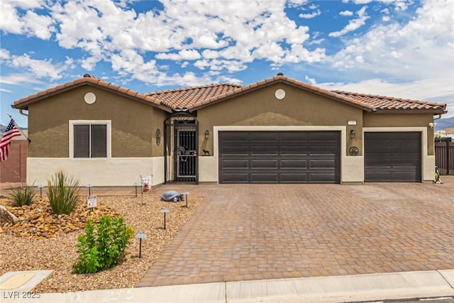 146 E Hawk Ave, Pahrump, NV 89060 - view of front of property featuring a garage, stucco siding, and decorative driveway
