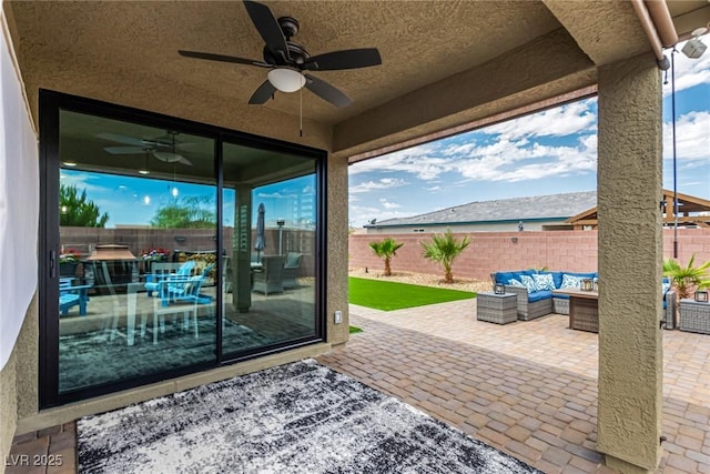 146 E Hawk Ave, Pahrump, NV 89060 - fenced backyard with a ceiling fan, a patio, and outdoor lounge area