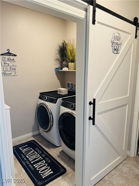 146 E Hawk Ave, Pahrump, NV 89060 - laundry room featuring a barn door and washer and dryer