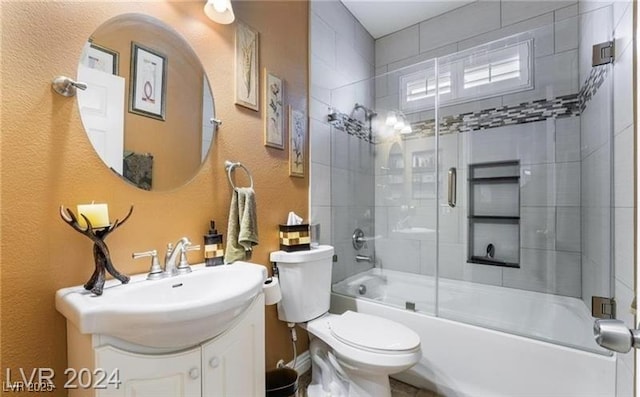 2253 Van Gogh Dr, Henderson, NV 89074 - full bathroom featuring a textured wall, combined bath / shower with glass door, and vanity