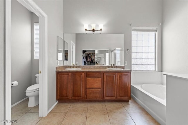 8929 Monte Oro Dr, Las Vegas, NV 89131 - full bathroom featuring double vanity, a garden tub, tile patterned flooring, and healthy amount of natural light