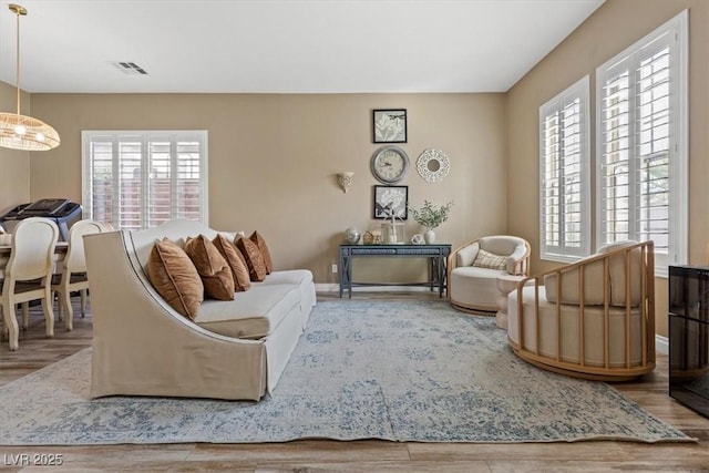 8929 Monte Oro Dr, Las Vegas, NV 89131 - living room featuring healthy amount of natural light, wood finished floors, and a chandelier