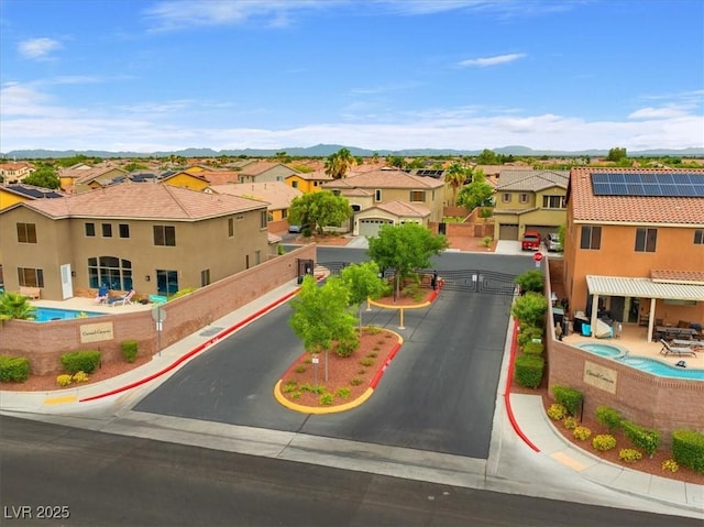 8929 Monte Oro Dr, Las Vegas, NV 89131 - aerial perspective of suburban area featuring a pool and a mountainous background