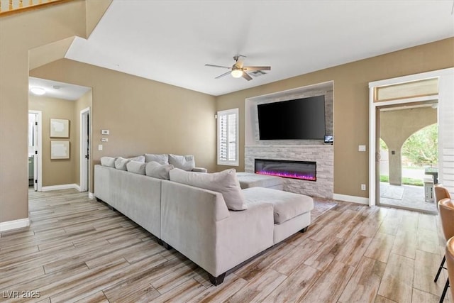 8929 Monte Oro Dr, Las Vegas, NV 89131 - living area with a ceiling fan, light wood-type flooring, and a glass covered fireplace