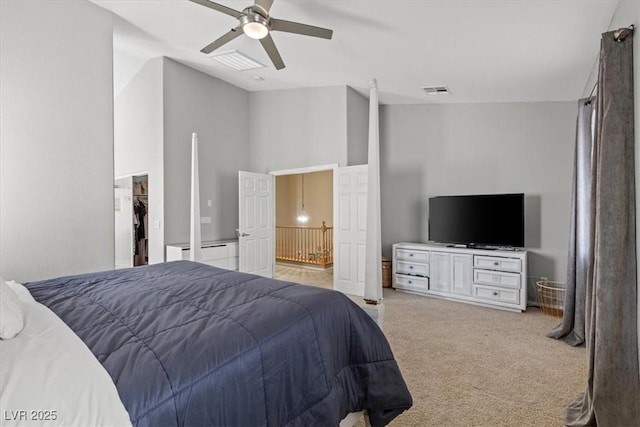 8929 Monte Oro Dr, Las Vegas, NV 89131 - bedroom with a walk in closet, light carpet, and a ceiling fan