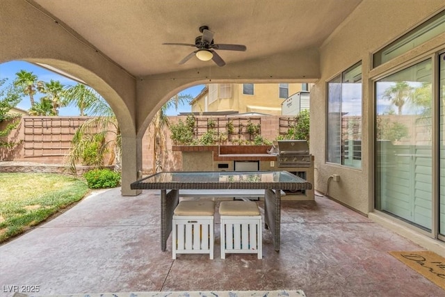 8929 Monte Oro Dr, Las Vegas, NV 89131 - fenced backyard with exterior kitchen, a patio, ceiling fan, and outdoor dining area