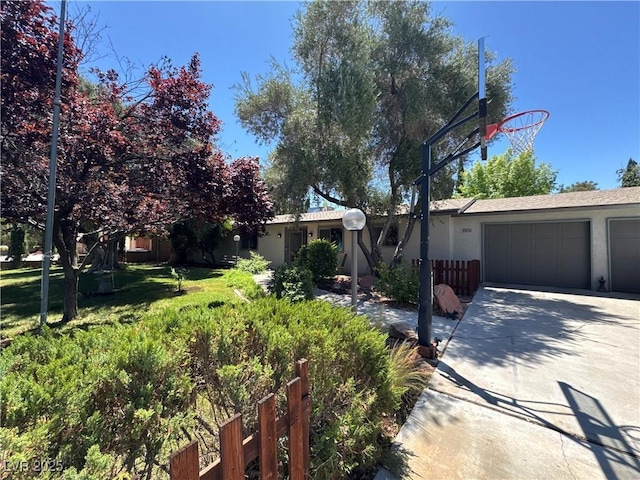 3551 Rochelle Ave, Las Vegas, NV 89121 - view of front of property featuring driveway, stucco siding, and a garage