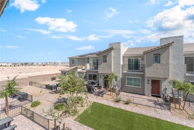 2620 Canary Yellow Ct, North Las Vegas, NV 89086 - rear view of property featuring a balcony, a patio area, and stucco siding