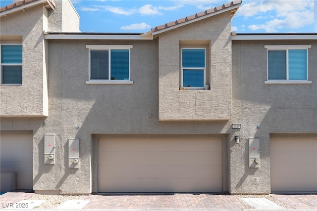2620 Canary Yellow Ct, North Las Vegas, NV 89086 - townhome / multi-family property with stucco siding, an attached garage, and a tile roof