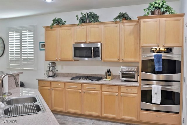 11240 Romette Ct, Las Vegas, NV 89141 - kitchen with stainless steel appliances, light brown cabinets, and light countertops
