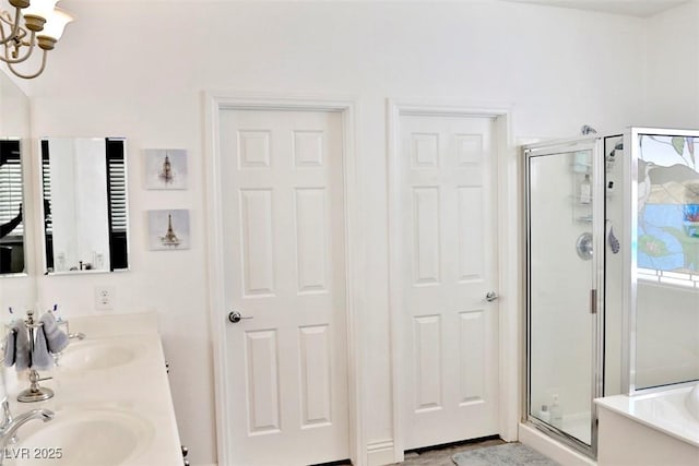 11240 Romette Ct, Las Vegas, NV 89141 - bathroom featuring a stall shower, double vanity, a chandelier, and a bath