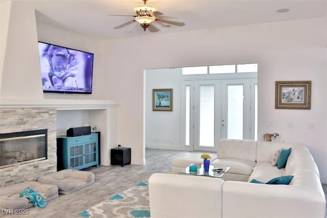 11240 Romette Ct, Las Vegas, NV 89141 - living area featuring a ceiling fan, wood finished floors, and a fireplace
