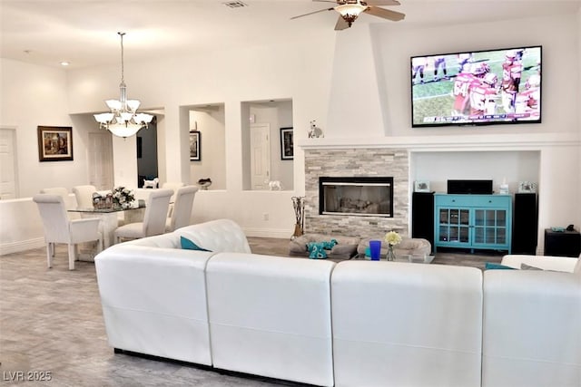 11240 Romette Ct, Las Vegas, NV 89141 - living room featuring a chandelier, ceiling fan, and a stone fireplace