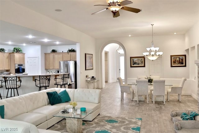 11240 Romette Ct, Las Vegas, NV 89141 - living area with arched walkways, a ceiling fan, light wood finished floors, a chandelier, and recessed lighting