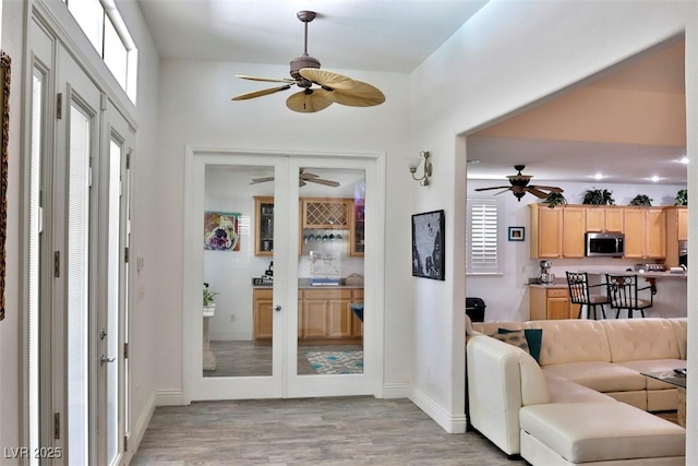 11240 Romette Ct, Las Vegas, NV 89141 - living area featuring french doors, a ceiling fan, and light wood-style flooring