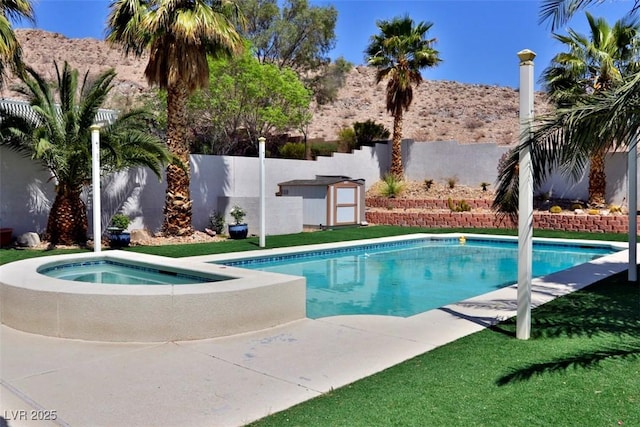 11240 Romette Ct, Las Vegas, NV 89141 - view of pool featuring a fenced backyard, a storage shed, and a pool with connected hot tub