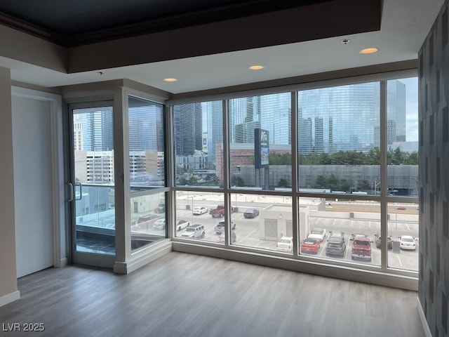 4575 Dean Martin Dr Unit 705, Las Vegas, NV 89103 - unfurnished room featuring wood finished floors, crown molding, a view of city, and recessed lighting