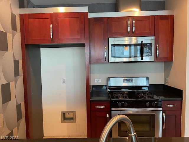 4575 Dean Martin Dr Unit 705, Las Vegas, NV 89103 - kitchen with stainless steel appliances, dark countertops, and reddish brown cabinets