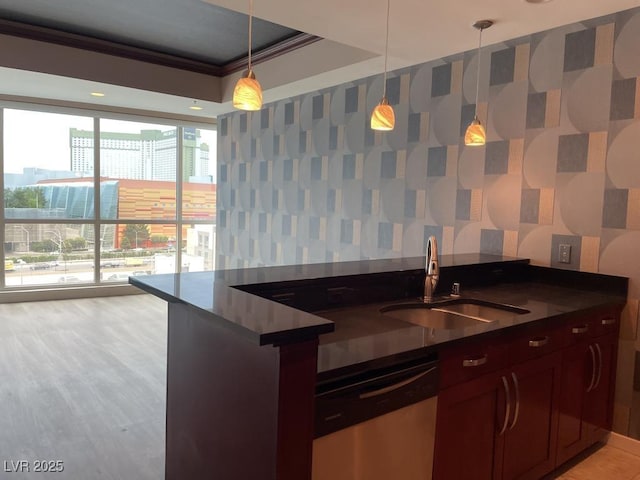 4575 Dean Martin Dr Unit 705, Las Vegas, NV 89103 - kitchen featuring stainless steel dishwasher, dark countertops, pendant lighting, wallpapered walls, and crown molding
