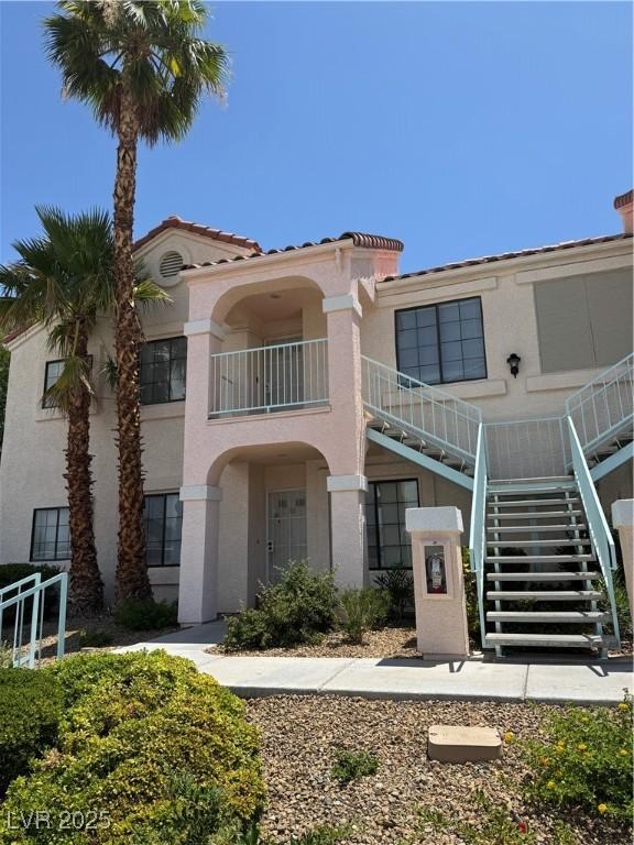 4831 S Torrey Pines Dr Unit 204, Las Vegas, NV 89103 - view of front of property featuring stairs, stucco siding, and a tile roof