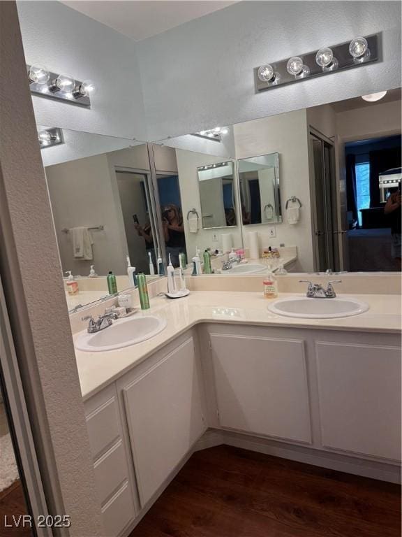 4831 S Torrey Pines Dr Unit 204, Las Vegas, NV 89103 - full bathroom featuring double vanity and wood finished floors