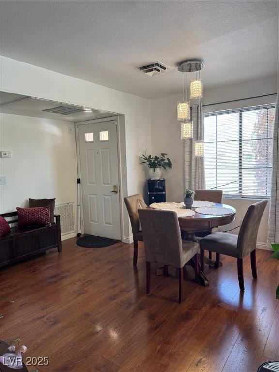 4831 S Torrey Pines Dr Unit 204, Las Vegas, NV 89103 - dining space with dark wood-style floors and a textured ceiling