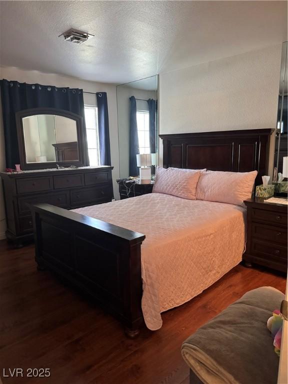 4831 S Torrey Pines Dr Unit 204, Las Vegas, NV 89103 - bedroom featuring dark wood-type flooring and a textured ceiling