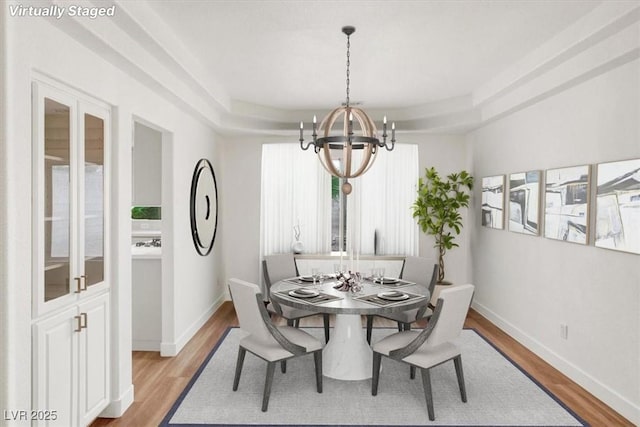 9824 Babys Breath Ct, Las Vegas, NV 89183 - dining room featuring a chandelier and light wood-style flooring
