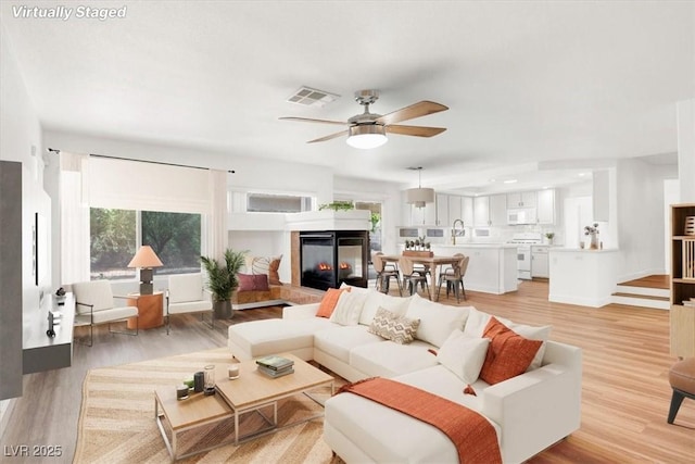 9824 Babys Breath Ct, Las Vegas, NV 89183 - living room with plenty of natural light, light wood-style floors, and ceiling fan
