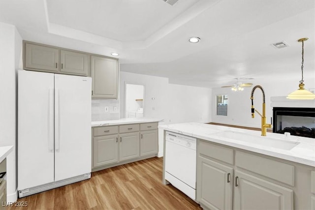 9824 Babys Breath Ct, Las Vegas, NV 89183 - kitchen featuring white appliances, light wood-style floors, gray cabinets, recessed lighting, and hanging light fixtures