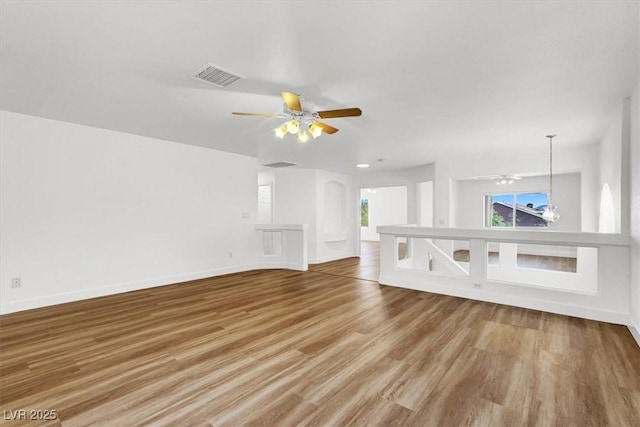 9824 Babys Breath Ct, Las Vegas, NV 89183 - unfurnished living room featuring ceiling fan and wood finished floors
