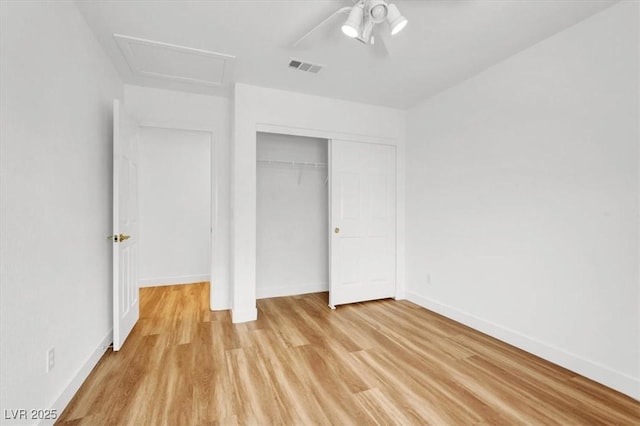 9824 Babys Breath Ct, Las Vegas, NV 89183 - unfurnished bedroom with light wood-style floors, attic access, a closet, and a ceiling fan