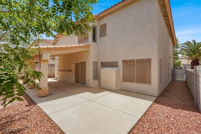 9824 Babys Breath Ct, Las Vegas, NV 89183 - back of house featuring a tiled roof, stucco siding, a patio area, a gate, and ceiling fan