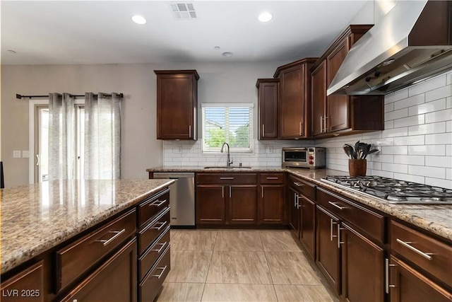176 Dunblane St, Henderson, NV 89012 - kitchen with wall chimney range hood, stainless steel appliances, light stone counters, backsplash, and recessed lighting