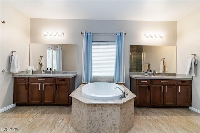 176 Dunblane St, Henderson, NV 89012 - full bathroom with two vanities, a bath, and walk in shower