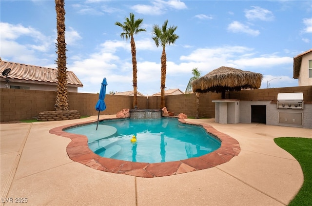 2064 Spiers Ave, Las Vegas, NV 89183 - view of swimming pool featuring an outdoor kitchen, a fenced backyard, a patio area, and a pool with connected hot tub