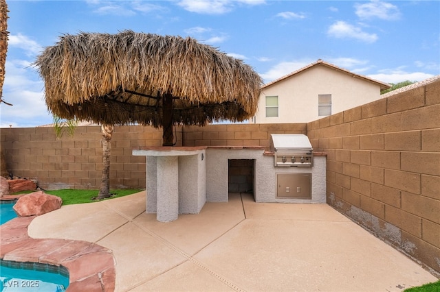 2064 Spiers Ave, Las Vegas, NV 89183 - fenced backyard with exterior kitchen and a patio area