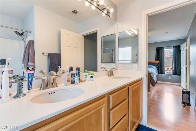 2064 Spiers Ave, Las Vegas, NV 89183 - ensuite bathroom with double vanity and wood finished floors