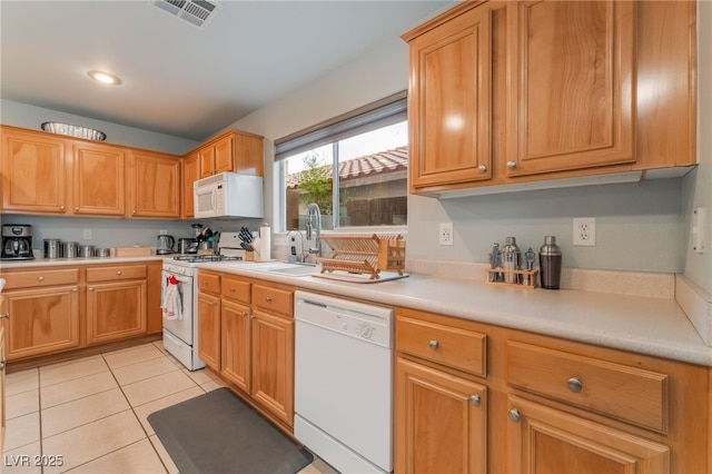 2064 Spiers Ave, Las Vegas, NV 89183 - kitchen with white appliances, light countertops, and light tile patterned floors
