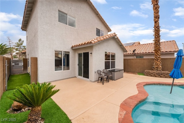 2064 Spiers Ave, Las Vegas, NV 89183 - rear view of house with stucco siding, a fenced backyard, and a tile roof