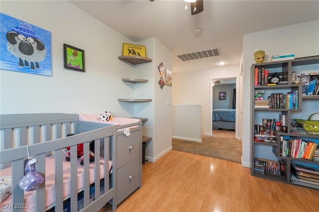 2064 Spiers Ave, Las Vegas, NV 89183 - bedroom with light wood-type flooring and a nursery area