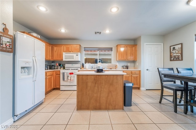 2064 Spiers Ave, Las Vegas, NV 89183 - kitchen with white appliances, light countertops, a center island, light tile patterned flooring, and recessed lighting