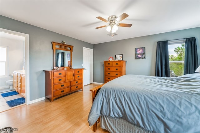 2064 Spiers Ave, Las Vegas, NV 89183 - bedroom with multiple windows, light wood-style flooring, ensuite bath, and ceiling fan