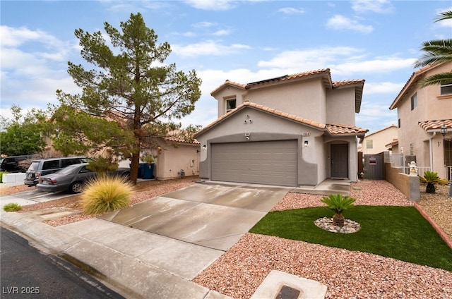 2064 Spiers Ave, Las Vegas, NV 89183 - mediterranean / spanish-style house with a garage, stucco siding, driveway, and a tile roof