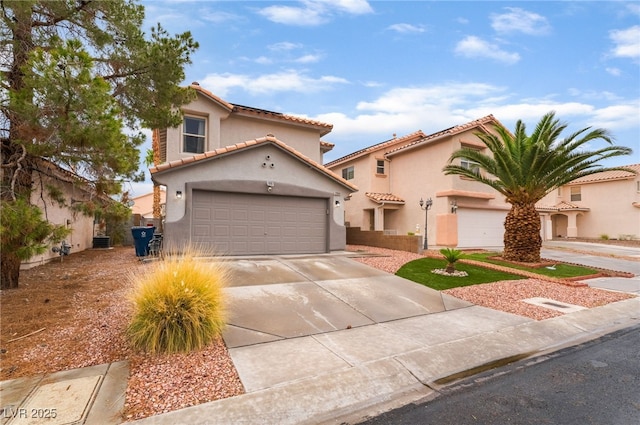 2064 Spiers Ave, Las Vegas, NV 89183 - mediterranean / spanish house featuring a tile roof, stucco siding, concrete driveway, and an attached garage