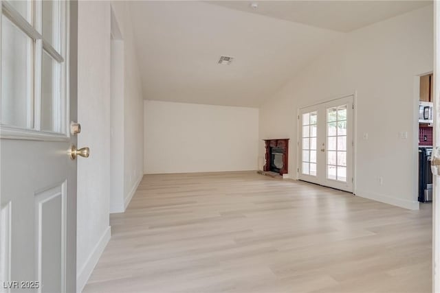 4630 Pratt Way, Las Vegas, NV 89147 - unfurnished living room featuring light wood-style floors, vaulted ceiling, and a fireplace